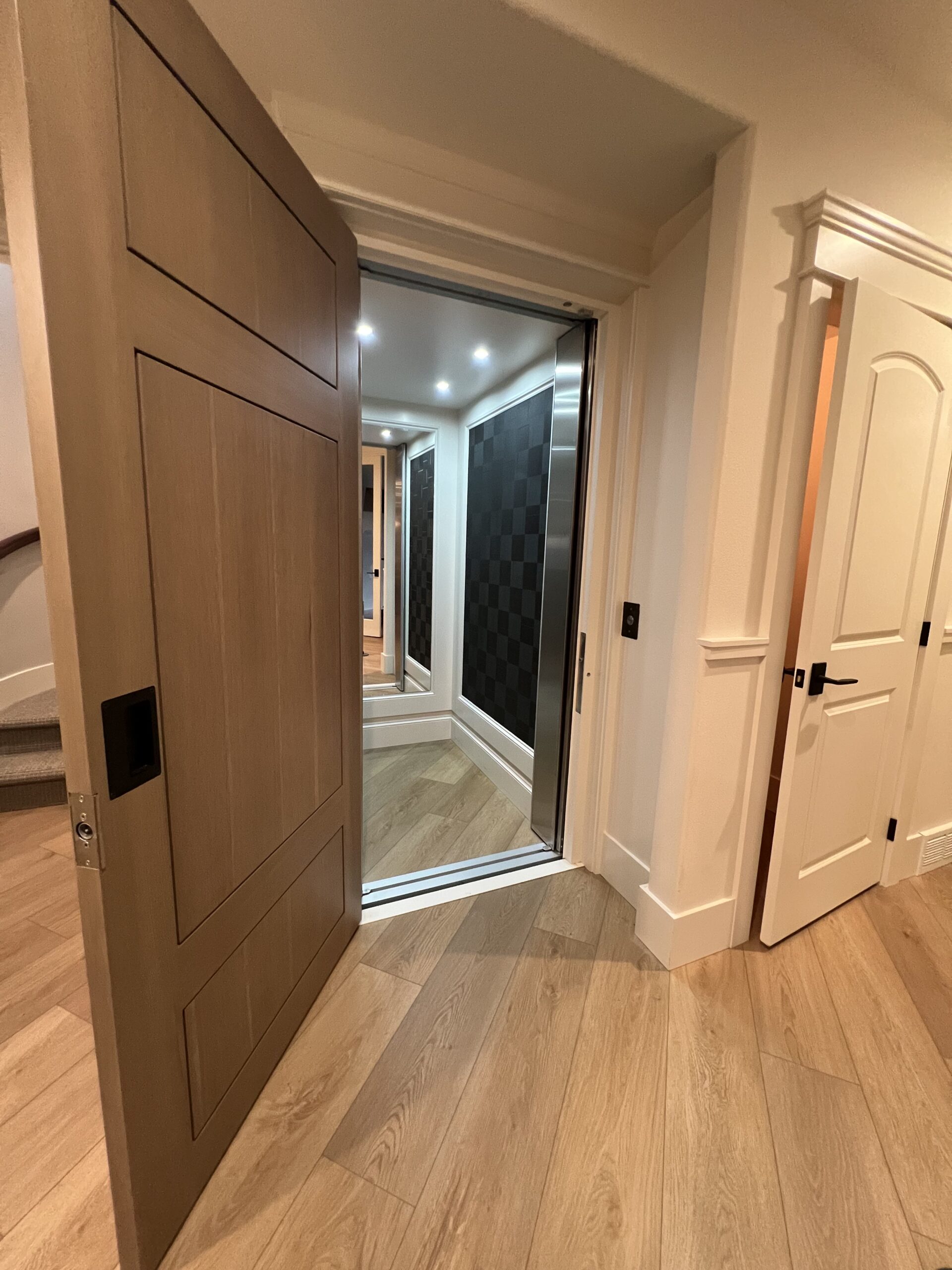 Custom home elevator with handcrafted woodwork
