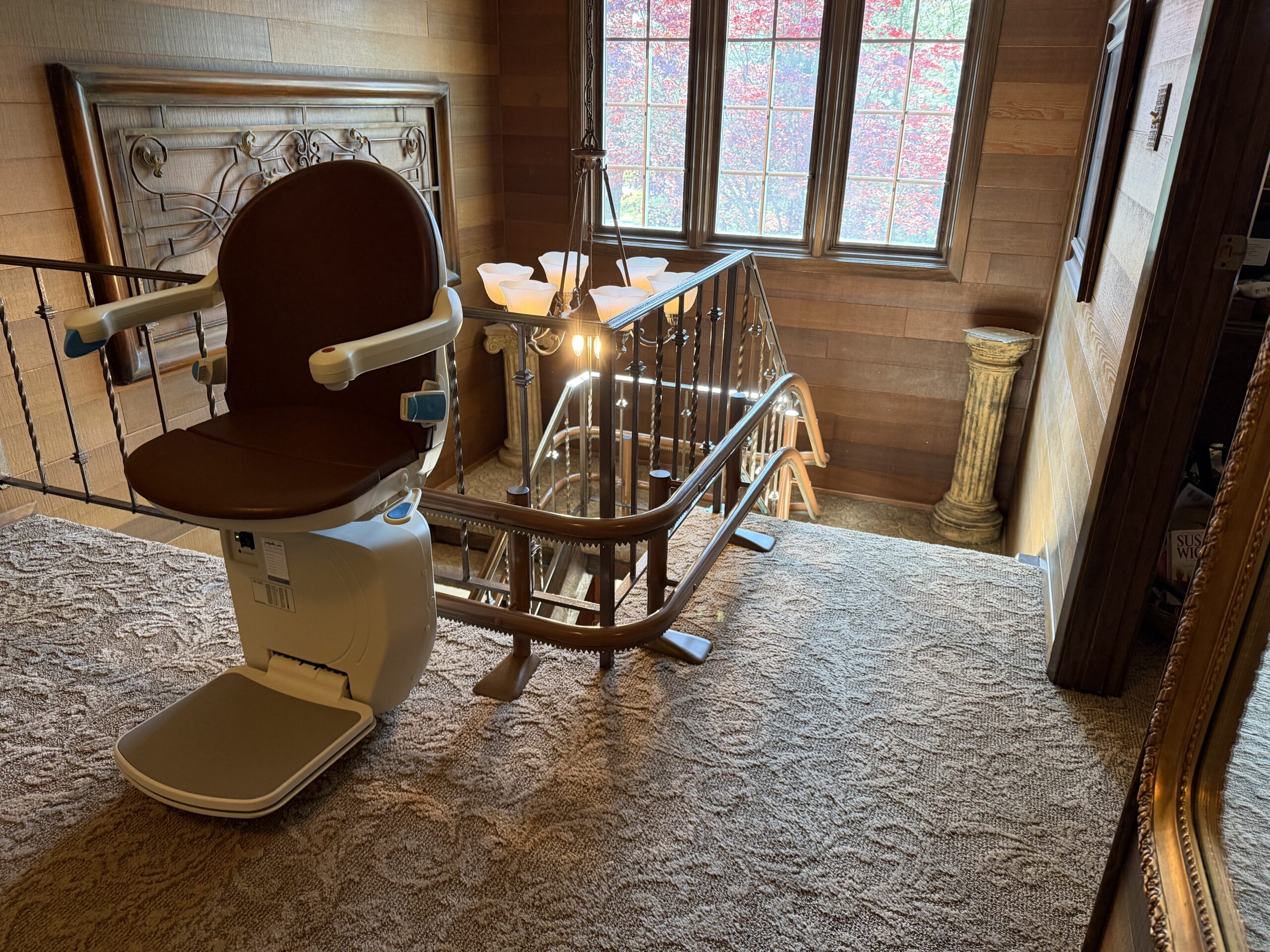 Residential stairlift ready for use on a staircase