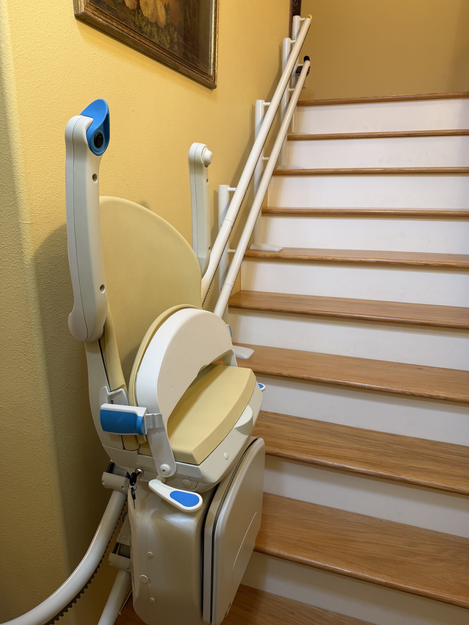 Stairlift chair folded along a home staircase